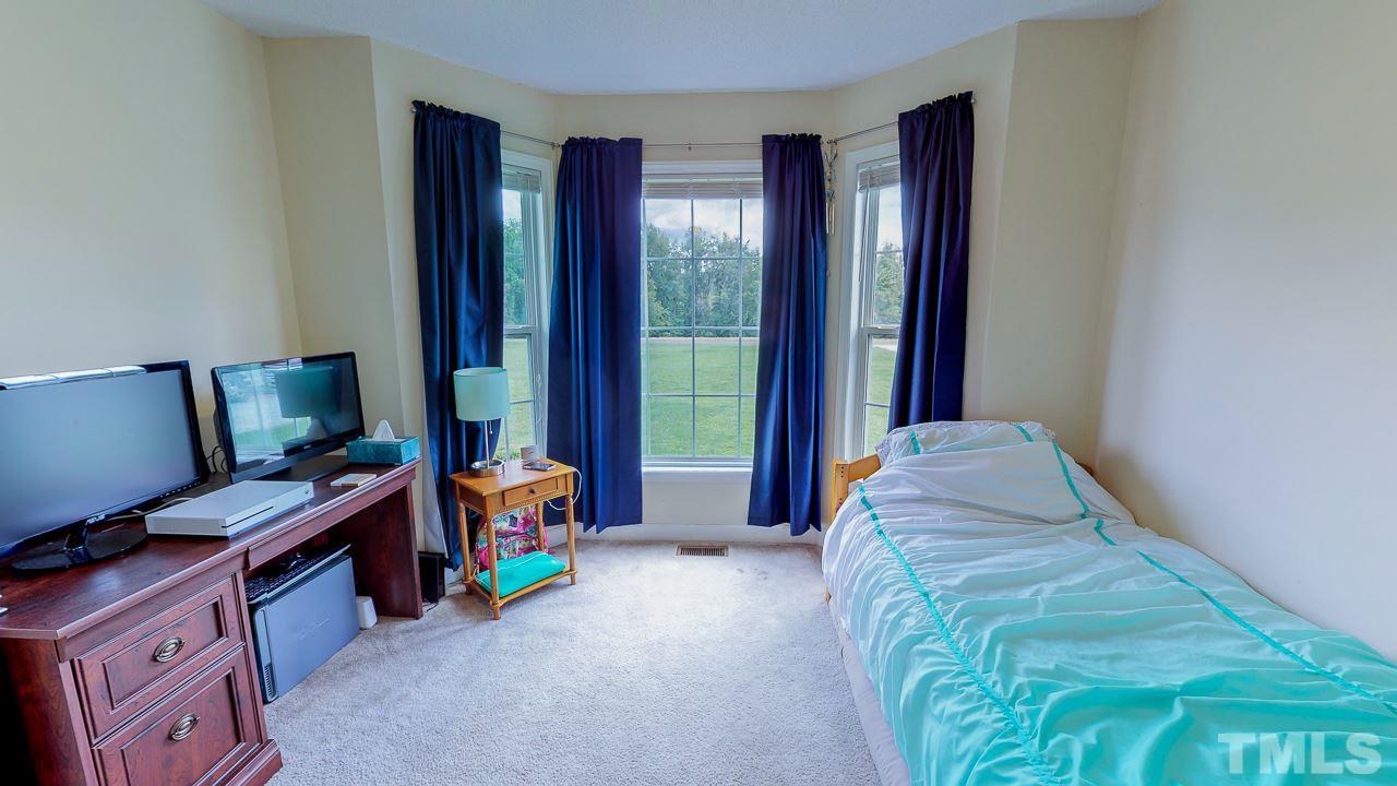 1130 Willie Gray Road Timberlake, NC 27583 - Photo 22 of 27 a bedroom with a bed and a window