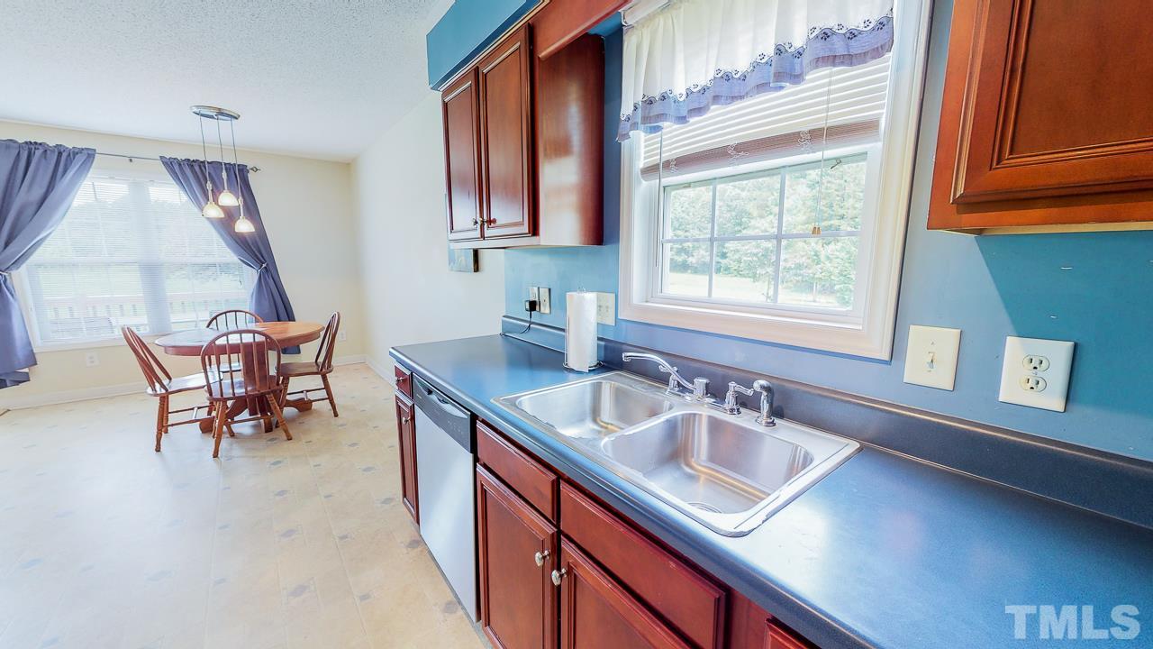 1130 Willie Gray Road Timberlake, NC 27583 - Photo 7 of 27 a kitchen with a sink cabinets and window