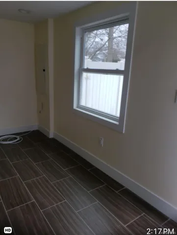 an empty room with wooden floor and closet