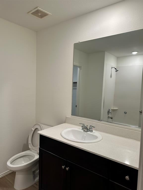 5906 Nyquist Way Forney, TX 75126 - Photo 21 of 27 Bathroom with vanity, wood finished floors, and a shower