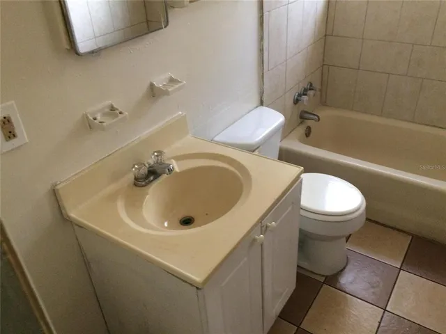 a bathroom with a sink a toilet and bathtub