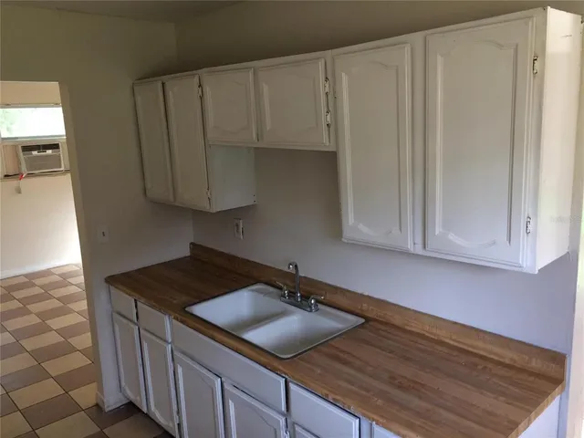 a kitchen with a sink and cabinets
