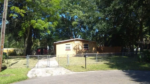 a backyard of a house with trampoline
