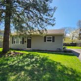 a view of a house with swimming pool and a yard