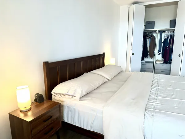 a bedroom with a bed and dresser