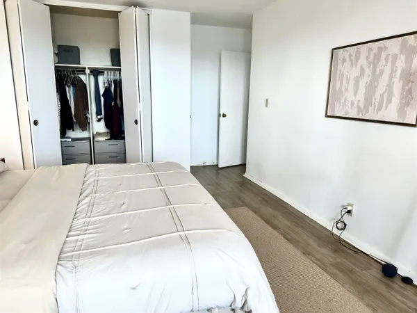 a bedroom with a bed and a mirror