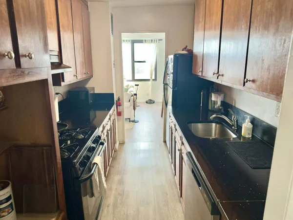 a kitchen with stainless steel appliances granite countertop a sink stove and refrigerator