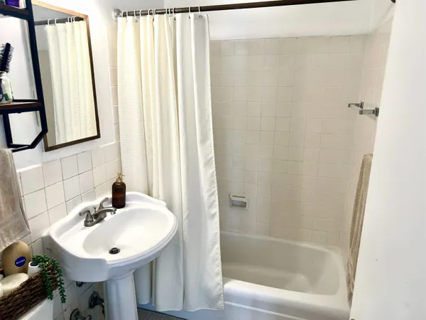 a bathroom with a sink a mirror and a bathtub