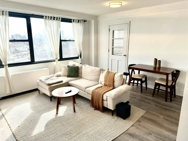 a living room with furniture and a large window