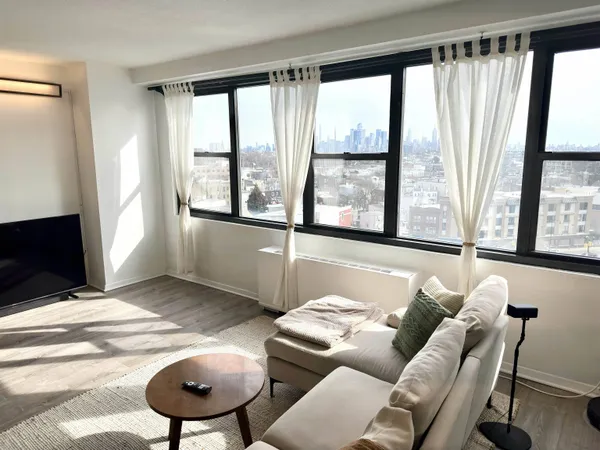 a living room with furniture and a floor to ceiling window