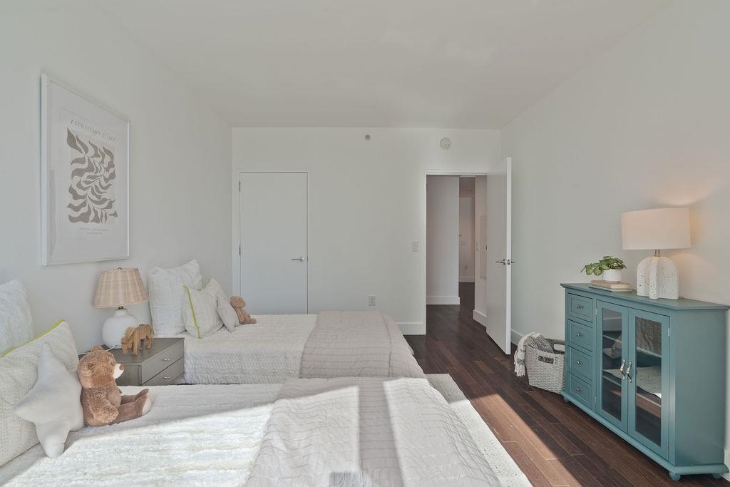 77 Hudson Street, Unit PH 4505 Jersey City, NJ 07302 - Photo 20 of 37 a bedroom with a large bed and a wooden floor