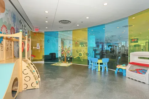 a room with gym equipment and large mirror
