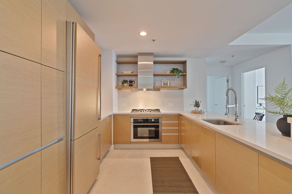 77 Hudson Street, Unit PH 4505 Jersey City, NJ 07302 - Photo 8 of 37 a kitchen with a sink stove and refrigerator