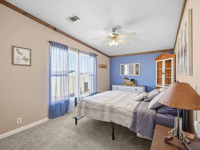 a bedroom with a bed dresser and a window