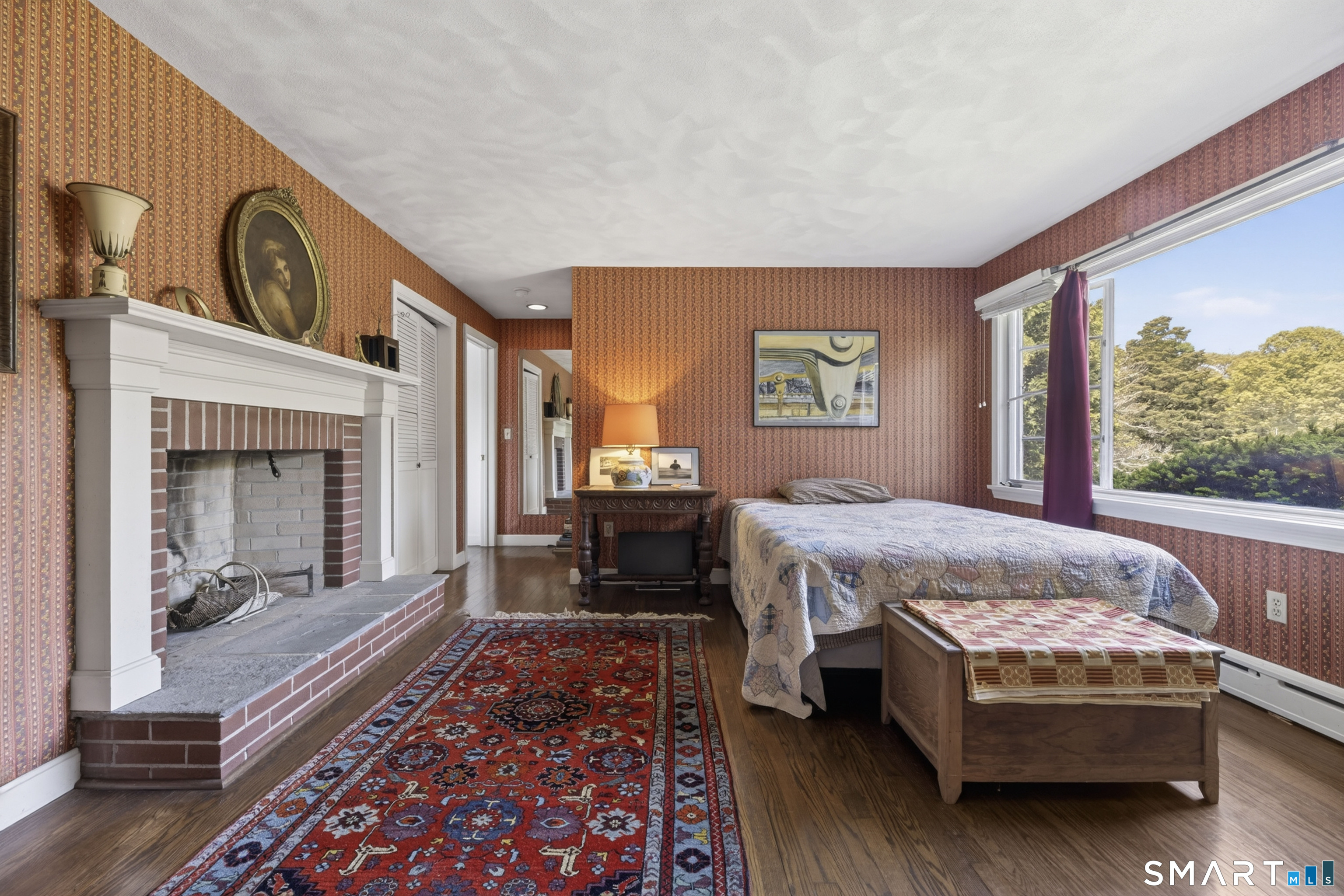 27 Wilbur Road Stonington, CT 06378 - Photo 14 of 40 a bed sitting in a spacious bedroom next to a window