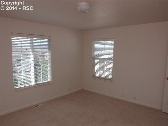 4011 Diamond Ridge View Colorado Springs, CO 80918 - Photo 16 of 17 12x14 Bedroom w/Neutral Carpet, Mountain View and adjoining Full Bath with Tub/Shower w/Tile Surround, His & Hers Closets plus Linen Closet, & Medicine Cabinet!