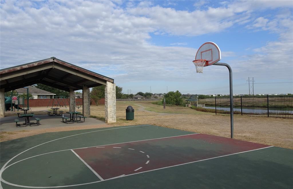 107 Thompson Trail Bastrop, TX 78602 - Photo 22 of 23 Community pavilion, basketball court, and one of the many ponds in the background