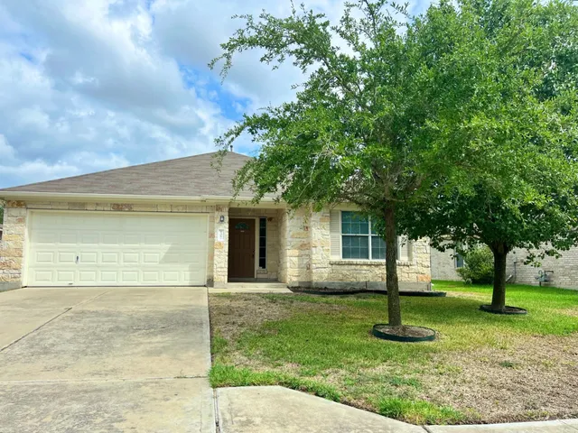 a view of a house with a backyard