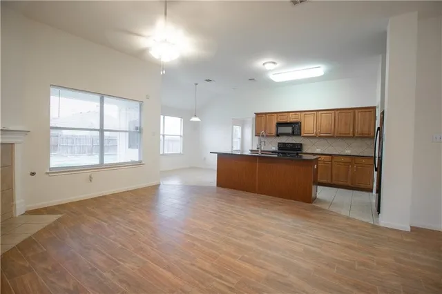 a view of kitchen with wooden floor and electronic appliances