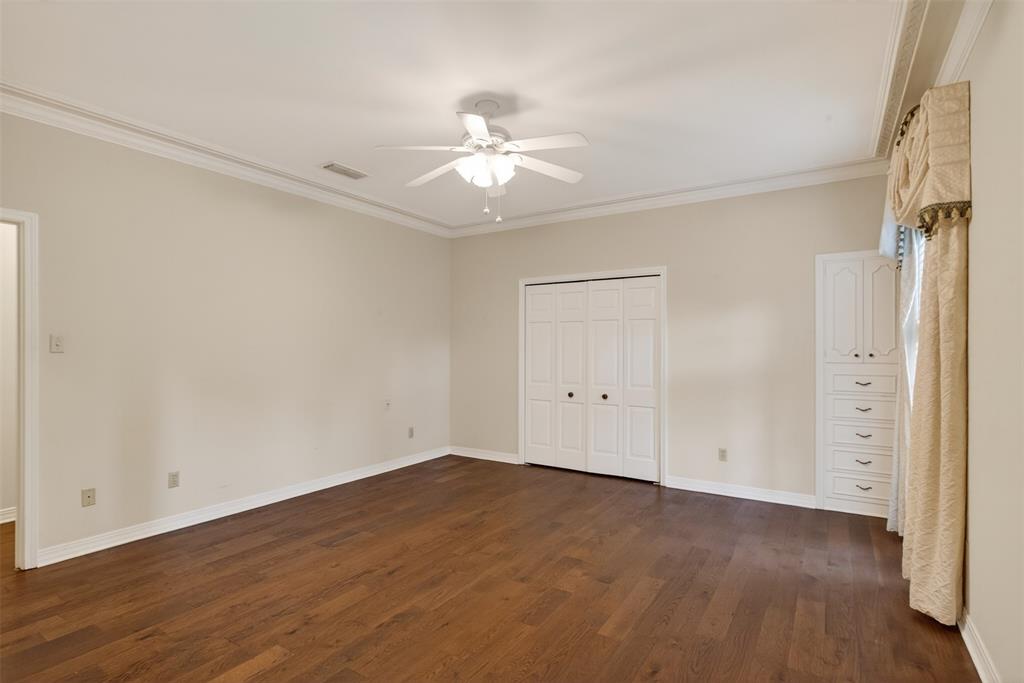 522 Rives Place Shreveport, LA 71106 - Photo 17 of 40 an empty room with wooden floor fan and windows
