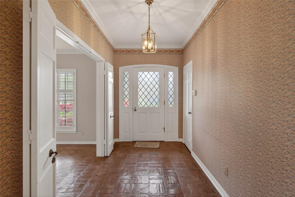 522 Rives Place Shreveport, LA 71106 - Photo 3 of 40 a view of a hallway with wooden floor and a chandelier