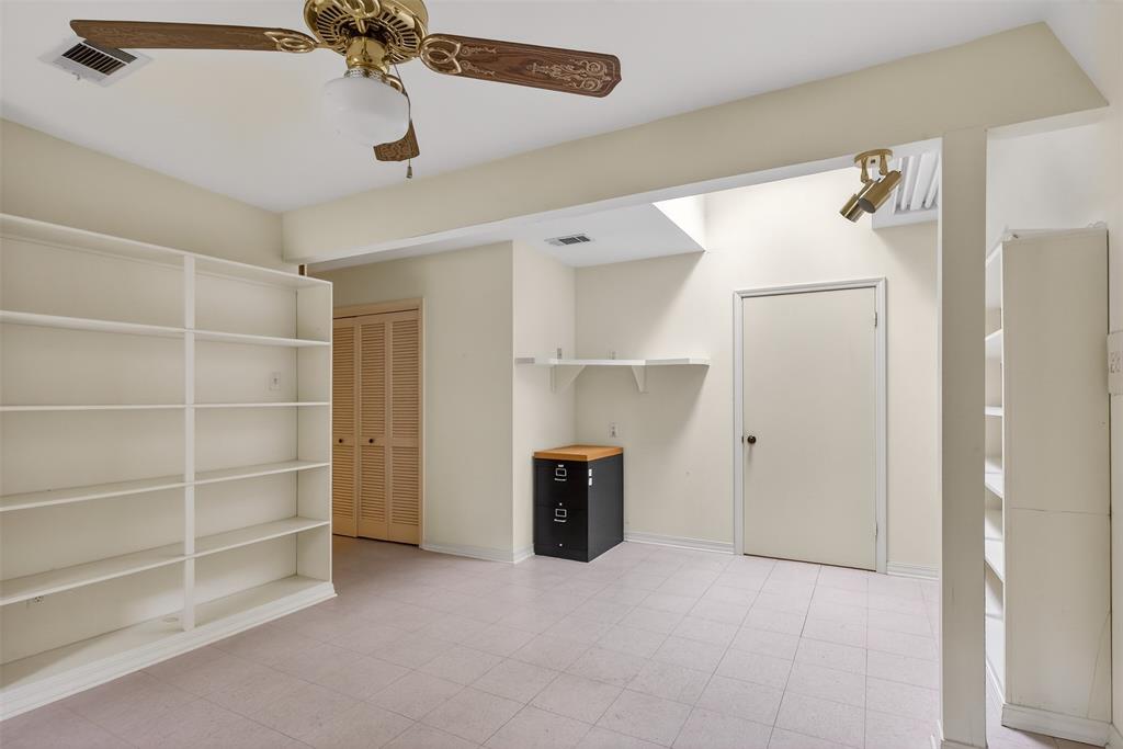 522 Rives Place Shreveport, LA 71106 - Photo 34 of 40 a view of an empty room with a cabinet and a ceiling fan