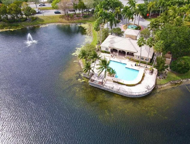 an aerial view of a house with swimming pool and outdoor space