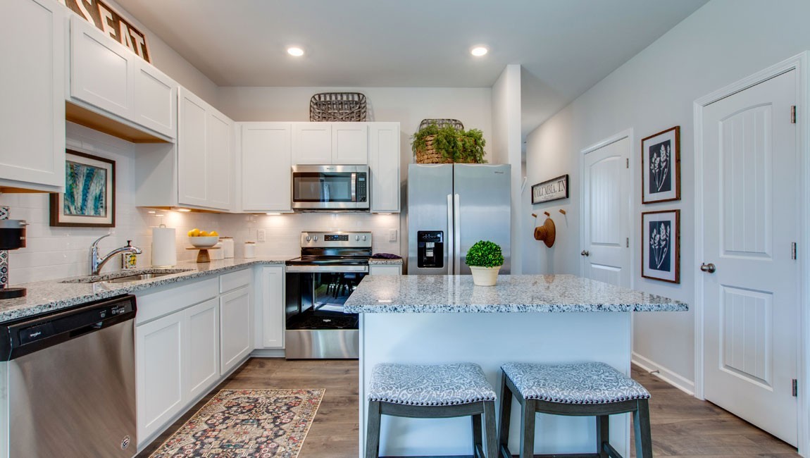 107 Grayson Circle Union City, TN 38261 - Photo 5 of 25 a kitchen with stainless steel appliances kitchen island granite countertop a stove a sink and a refrigerator
