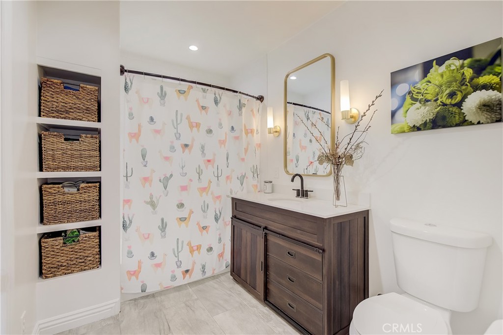 3743 North Studebaker Road Long Beach, CA 90808 - Photo 15 of 32 a bathroom with a sink toilet and shower