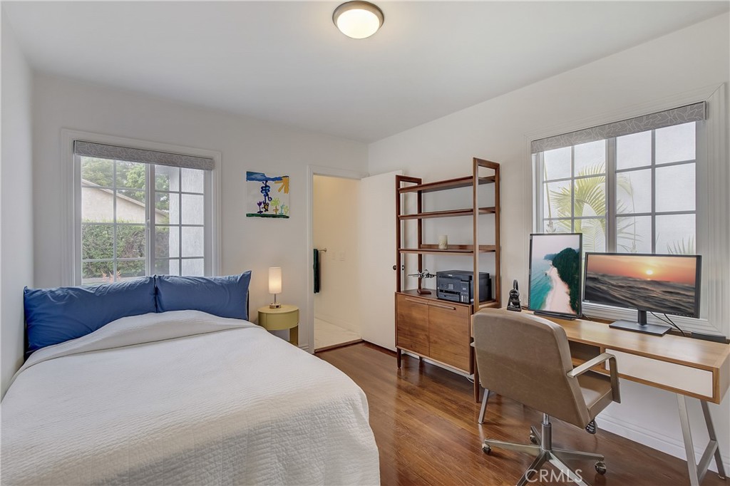 3743 North Studebaker Road Long Beach, CA 90808 - Photo 16 of 32 a bedroom with a bed and large windows