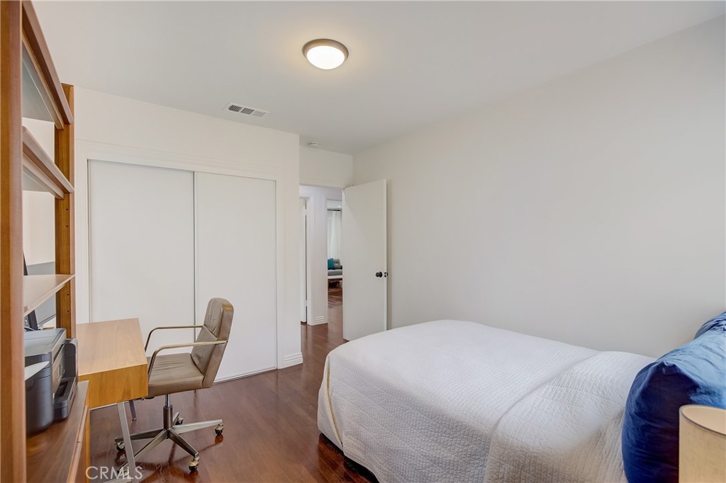 3743 North Studebaker Road Long Beach, CA 90808 - Photo 17 of 32 a bedroom with a bed and a chair in it