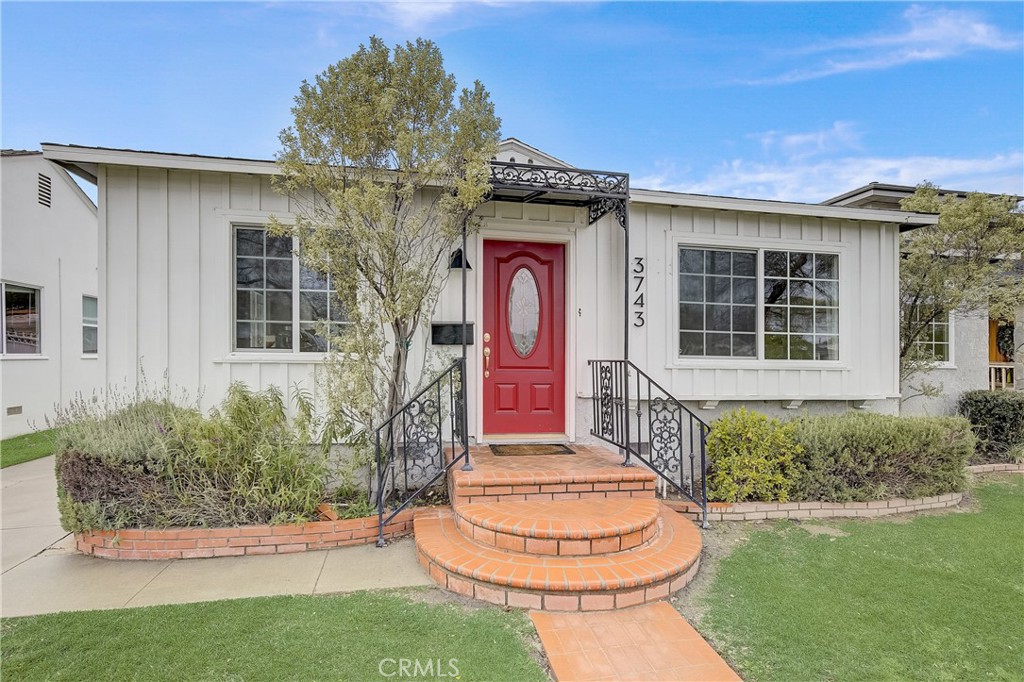 3743 North Studebaker Road Long Beach, CA 90808 - Photo 2 of 32 a front view of a house with a garden