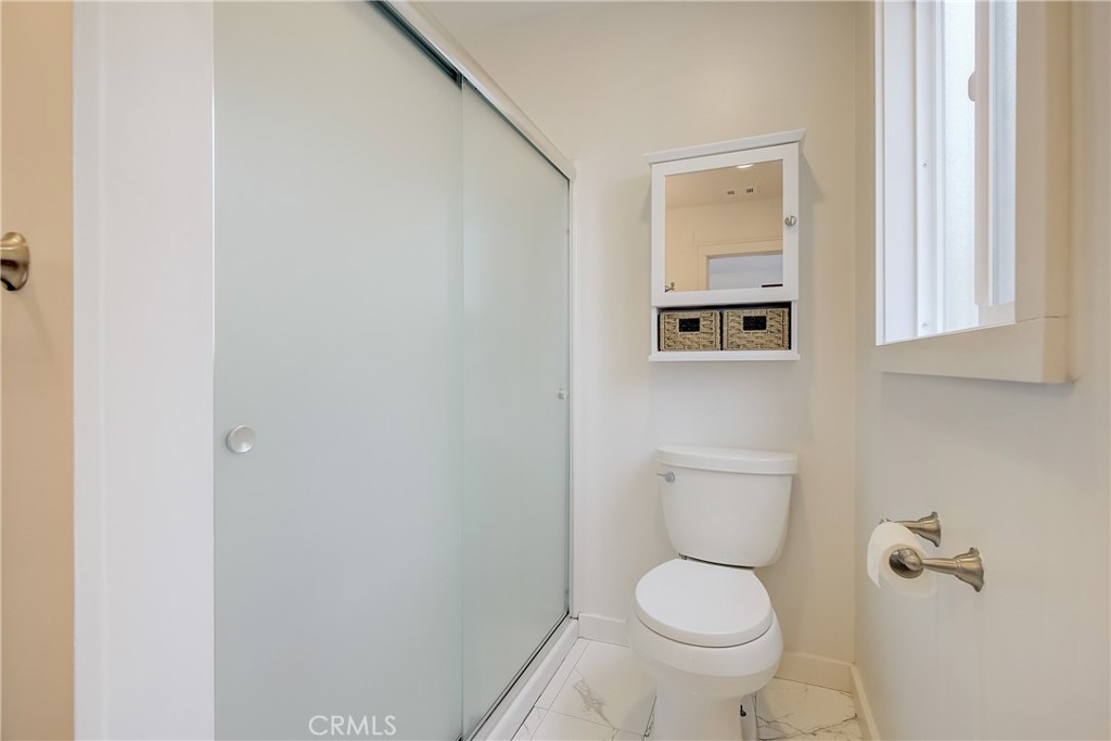 3743 North Studebaker Road Long Beach, CA 90808 - Photo 21 of 32 a white toilet sitting next to a bathroom sink
