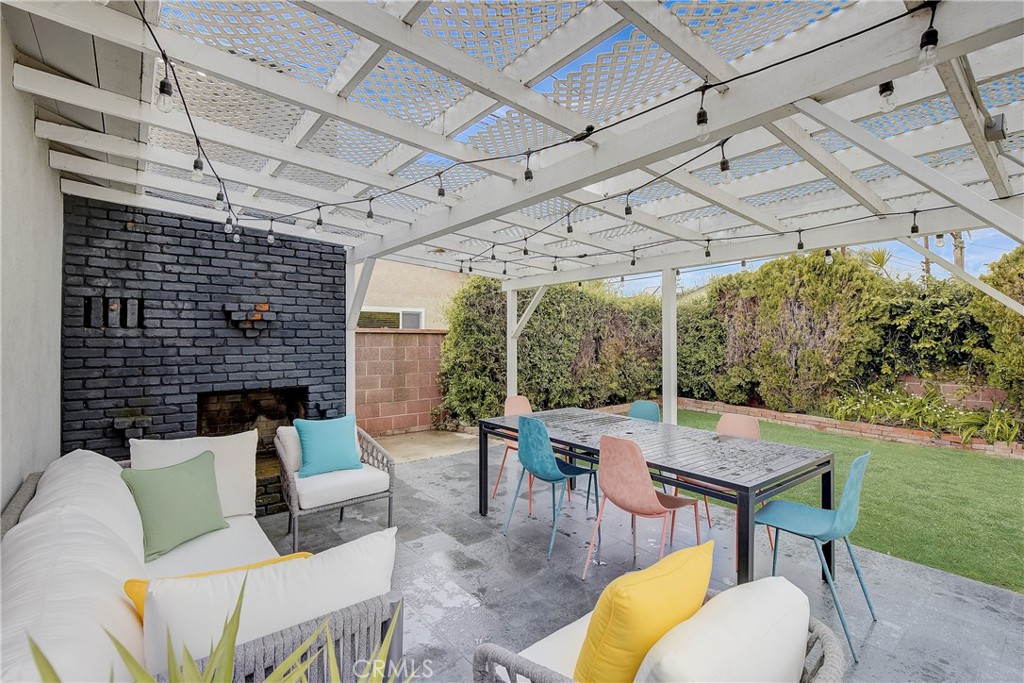 3743 North Studebaker Road Long Beach, CA 90808 - Photo 22 of 32 a view of a patio with a table and chairs and a barbeque