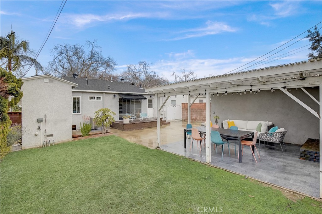 3743 North Studebaker Road Long Beach, CA 90808 - Photo 26 of 32 a view of a patio with table and chairs under an umbrella