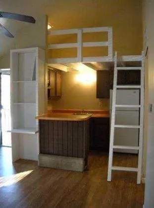 a view of walk in closet with wooden floor