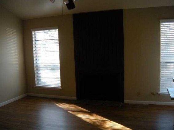 1000 West 26th Street, Unit 214 Austin, TX 78705 - Photo 4 of 7 a view of an empty room with wooden floor and a window
