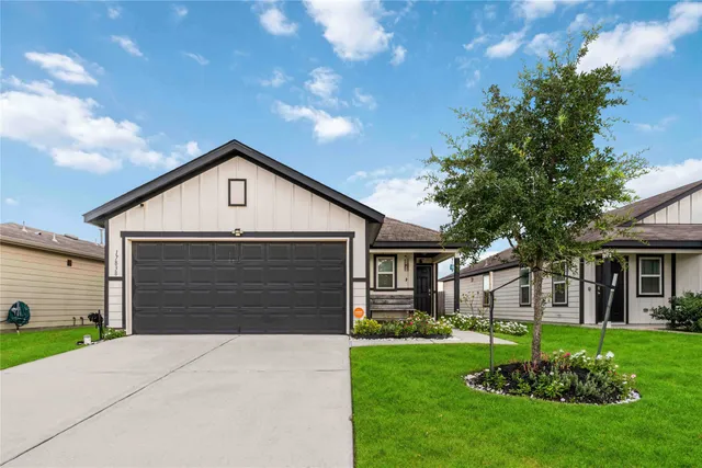 a front view of house with a garden