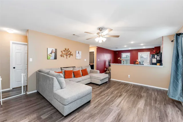 a living room with furniture and wooden floor