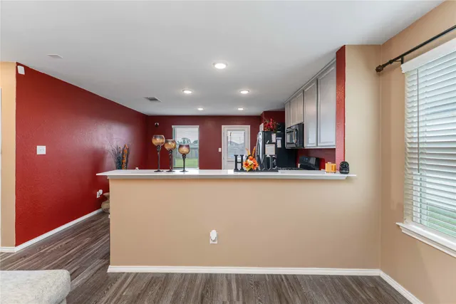a view of kitchen with stainless steel appliances granite countertop refrigerator sink and window