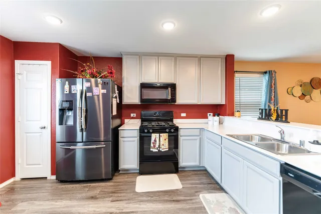 a kitchen with stainless steel appliances granite countertop a refrigerator stove and sink