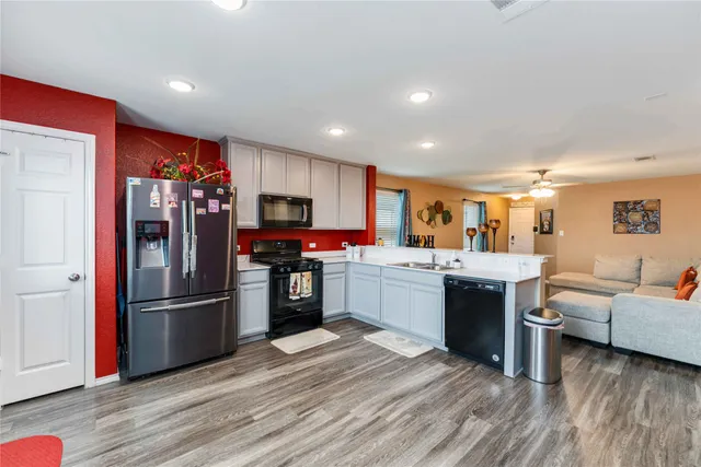 a kitchen with stainless steel appliances granite countertop a refrigerator stove and oven