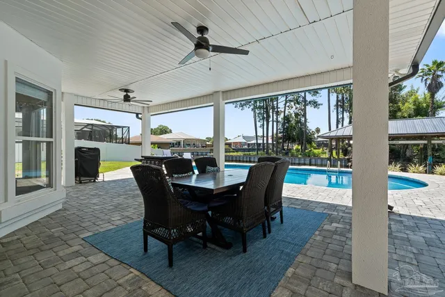 a living room with furniture a large window and a table