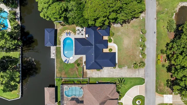 an aerial view of residential houses with outdoor space and swimming pool