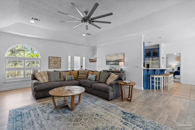 a kitchen with stainless steel appliances granite countertop a sink and wooden cabinets