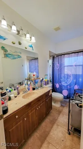 a spacious bathroom with a double vanity sink and a mirror