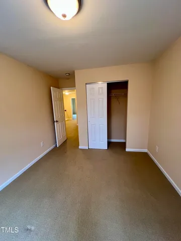 an empty room with a view of hallway