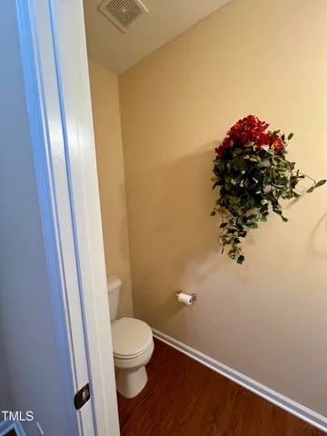 a bathroom with a sink and mirror with toilet