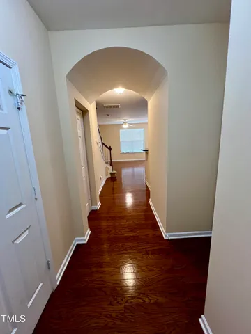 a view of a hallway with wooden floor