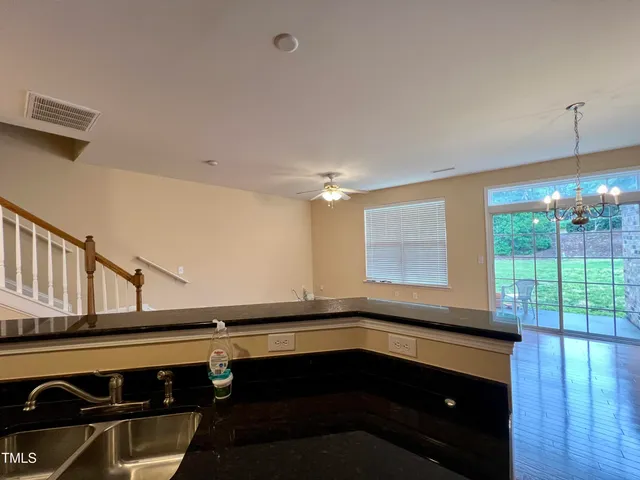 a kitchen with a sink and a stove top oven